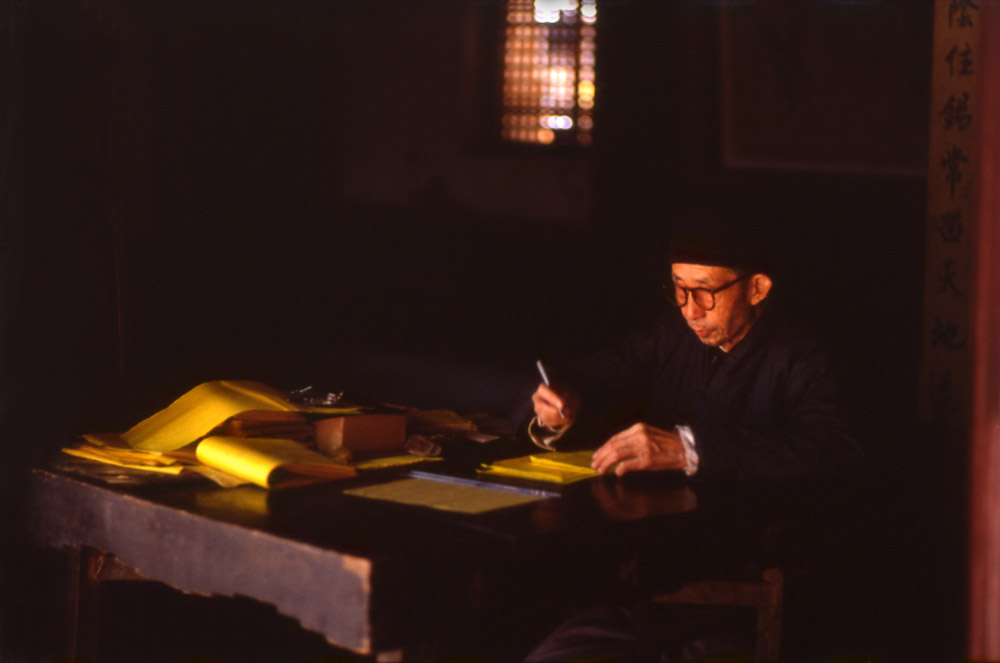 Yellow light on prayers writter. Kumming, China 1983 