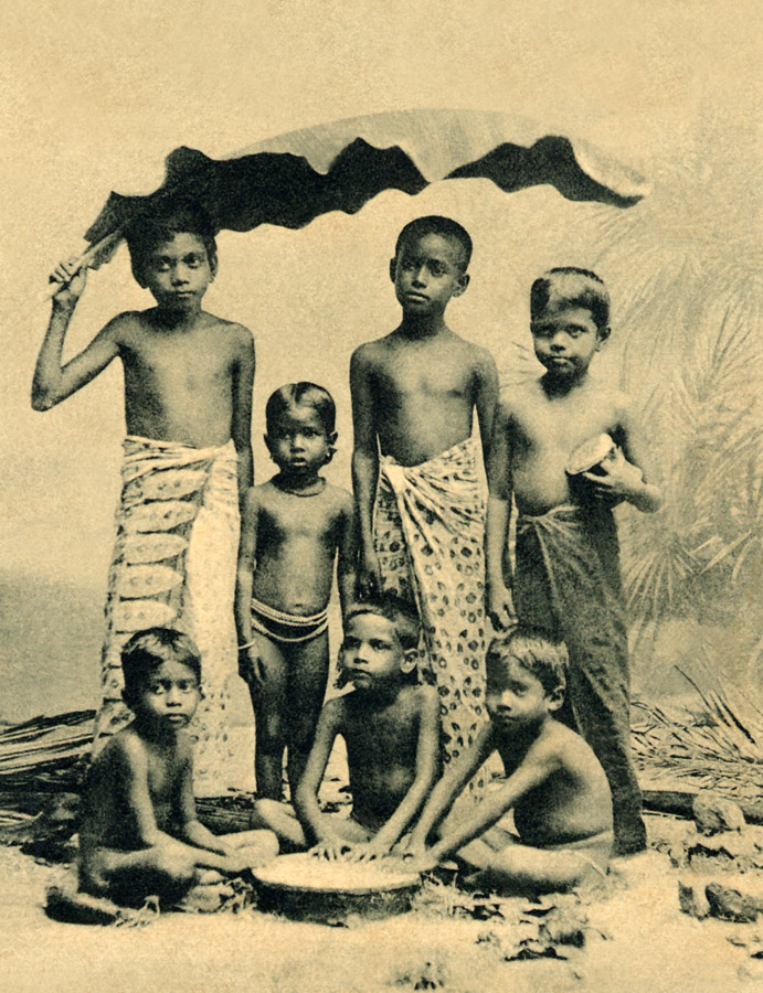 Ceylon. Children under a banana leaf
