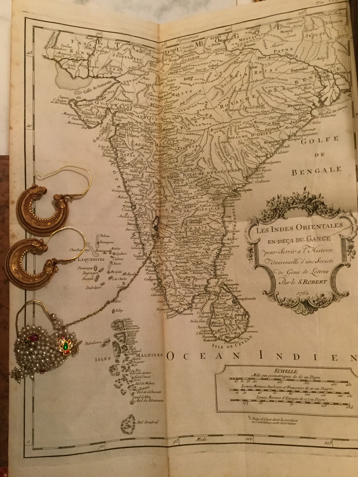 Map of India from Histoire Generale des Voyages with Indian gold jewellery '' naths'' and rajasthani hearrings.