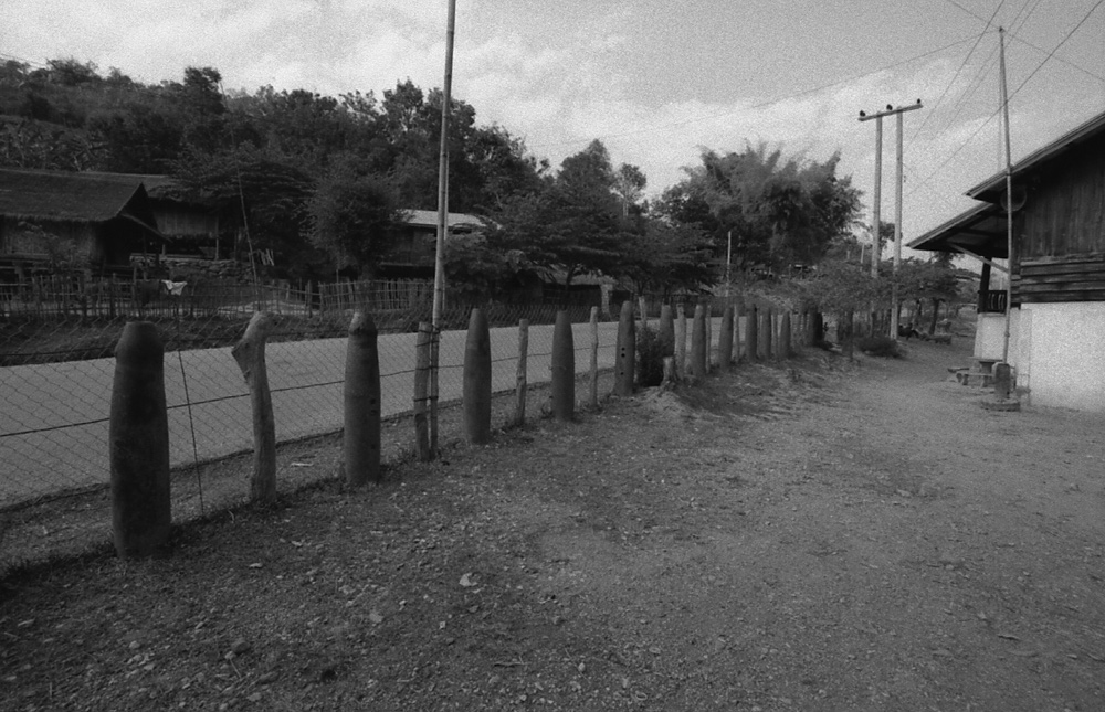 Very often in Laos houses are sourrounded by unexploded bombs - © Carlo Sacco