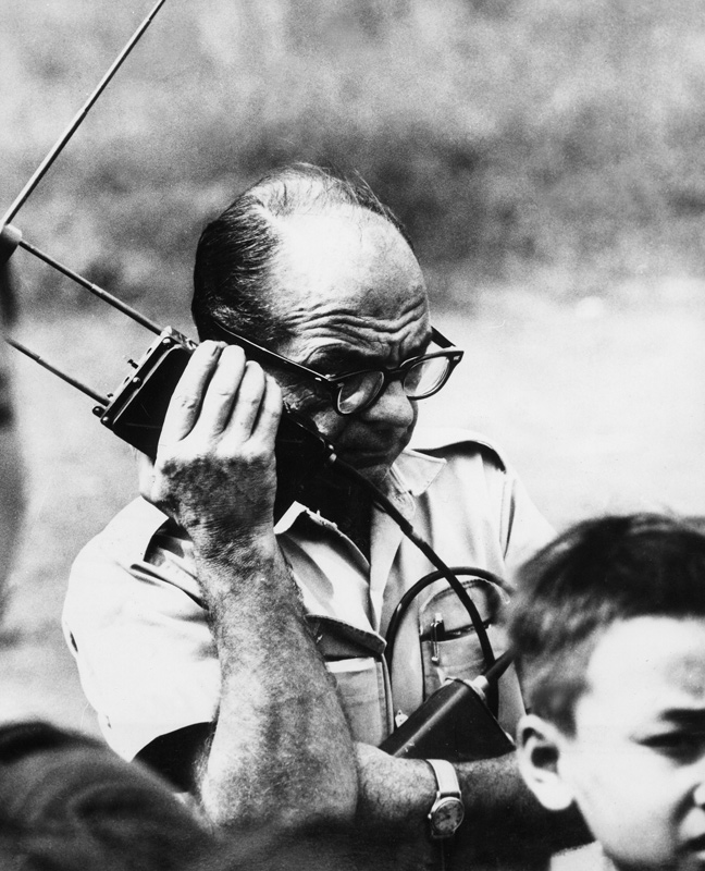 Edgar Buell calling at radio with planes in order to parachute