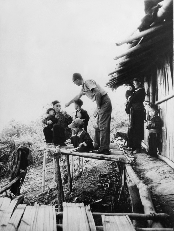 Edgar Buell visiting with Meo family in Huei Kimin. Laos 1962
