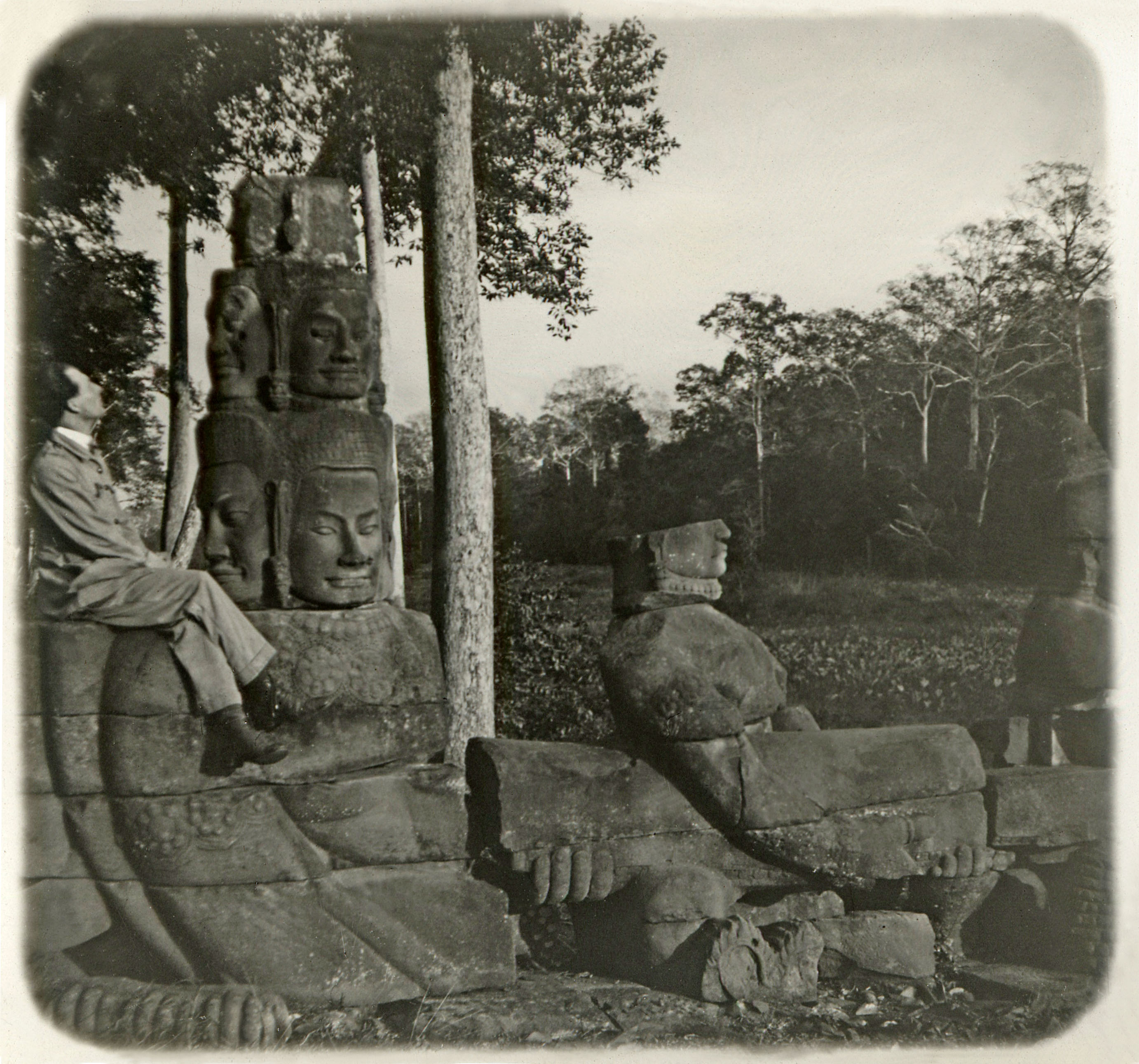 Cambodia. A french visitor is sitting along Giants and Monsters Alley. Angkor 1930 ca