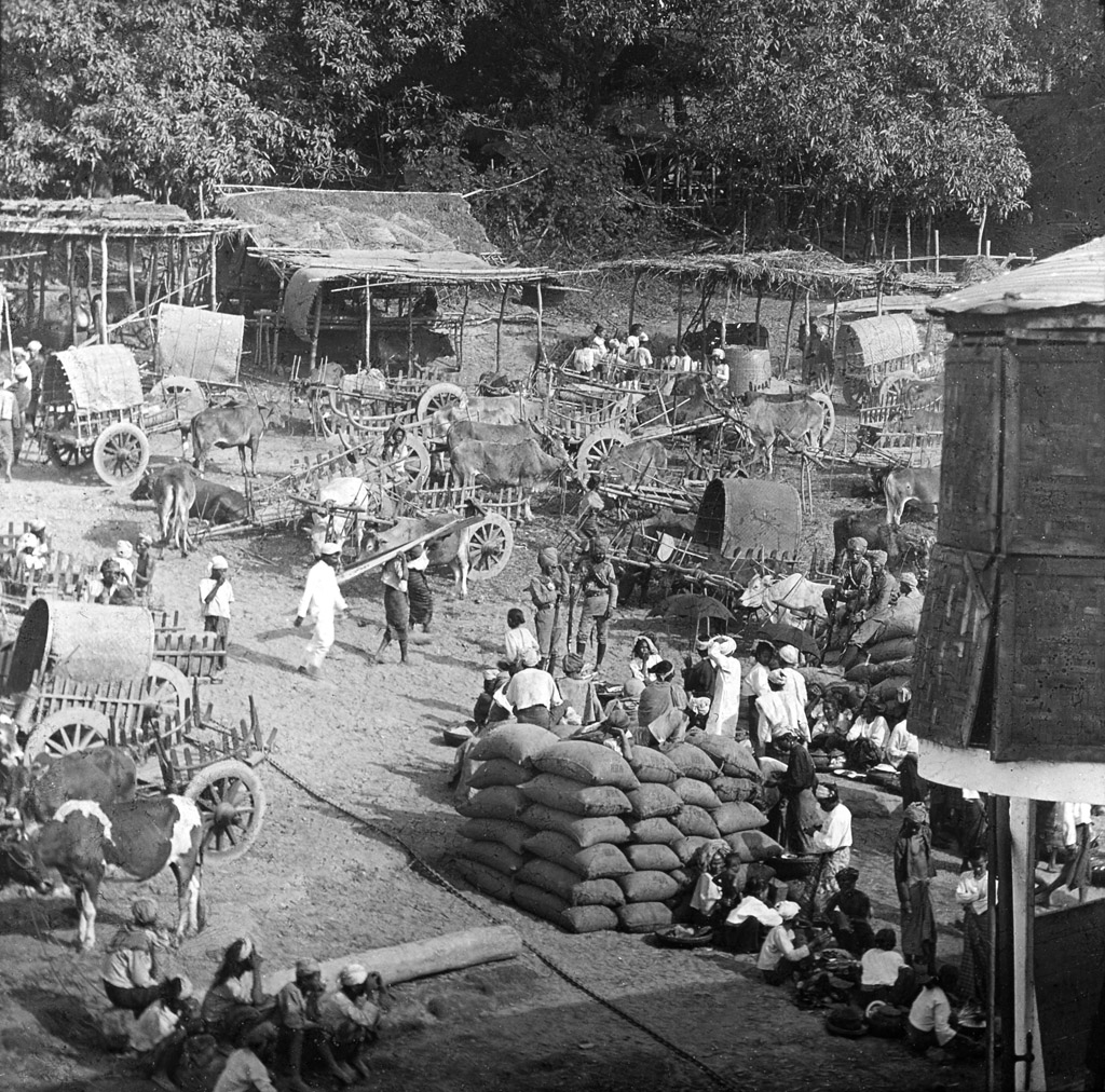 A crawded market patrolled by soldiers along Irrawady River. Burma end of XIX cent.