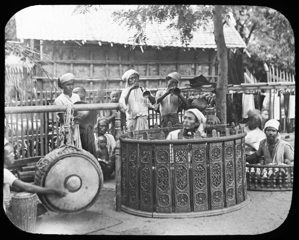 Burmese band performing with a variety of instruments. Burma 1910 ca