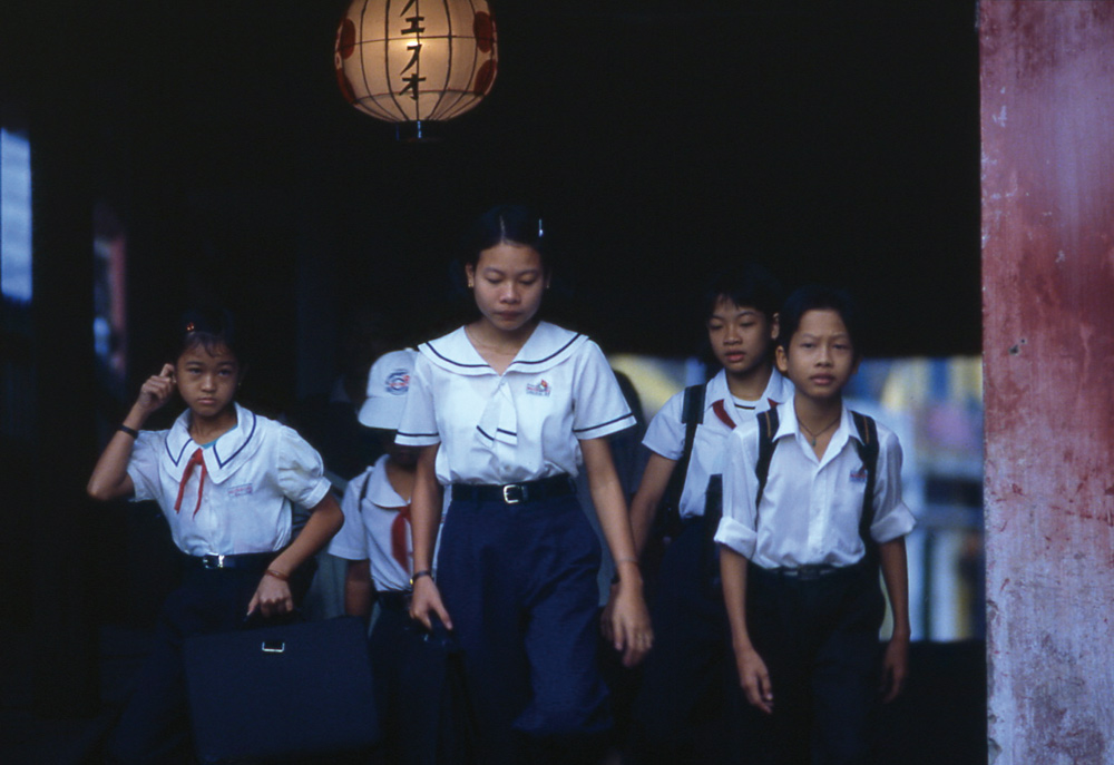 Japanese Bridge is on the road to school. Hoi An, Vietnam 2000 - © Carlo Sacco